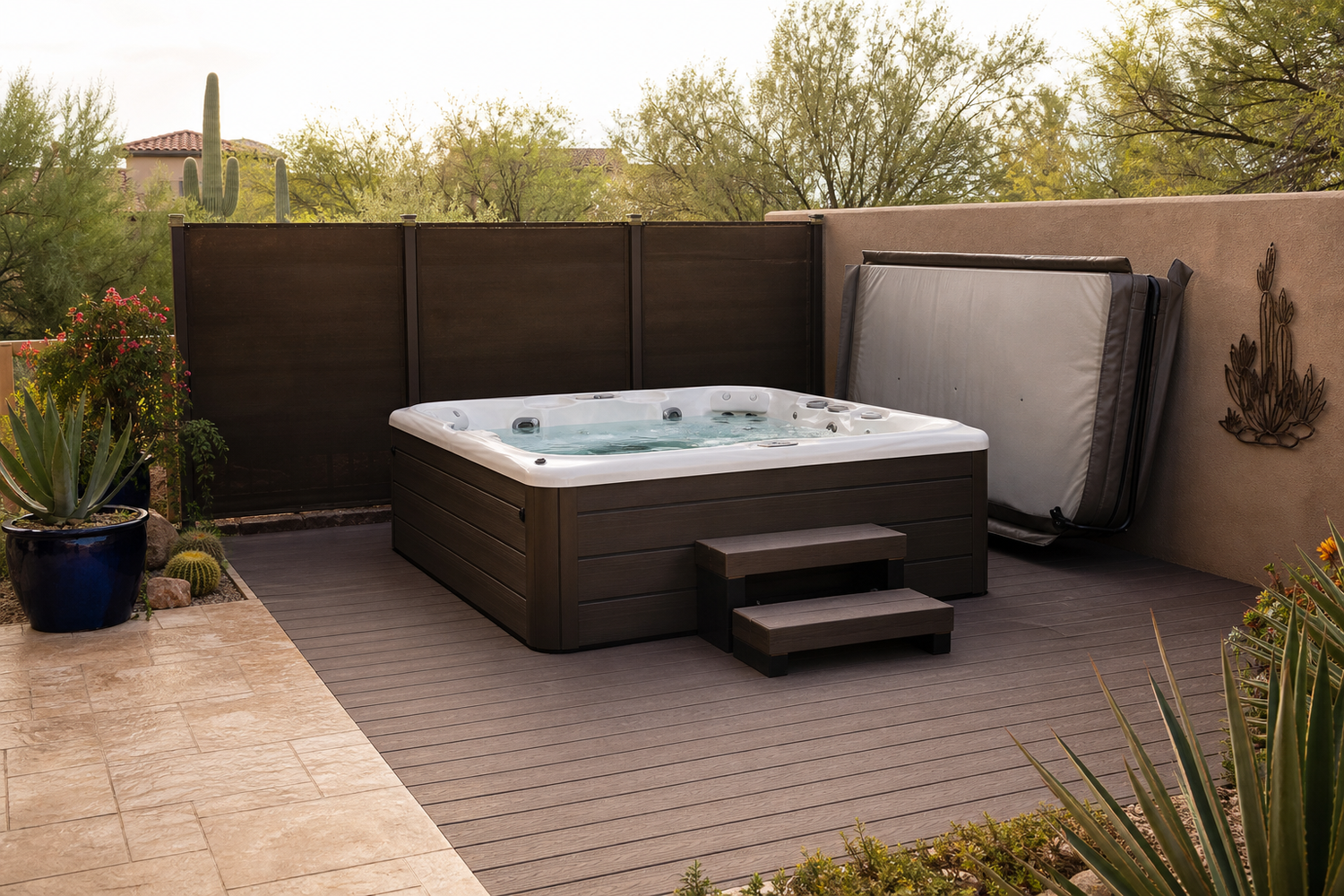 Covered hot tub patio with a windbreak in an Arizona backyard