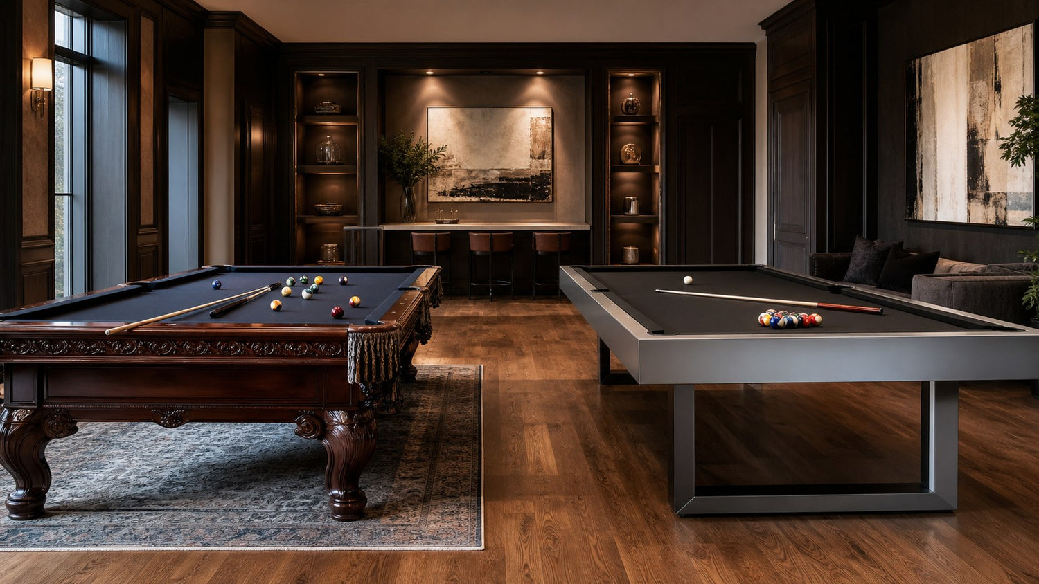 Ornate traditional pool table beside a sleek modern table in a residential game room